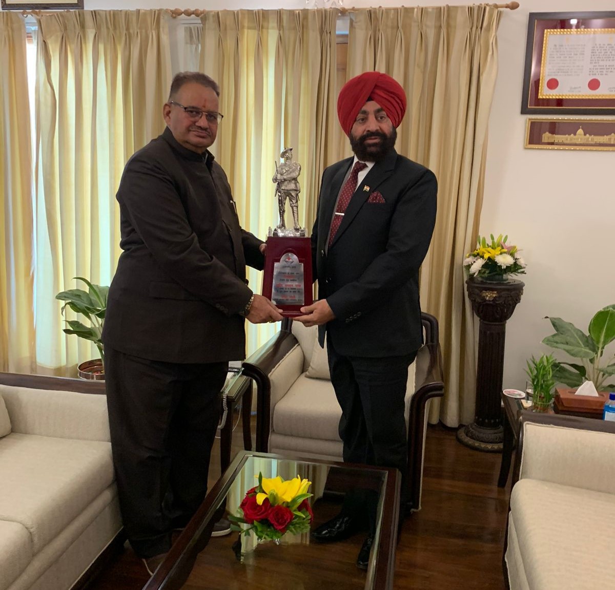 Sainik Welfare Minister Ganesh Joshi presenting a memento from Governor Lt Gen Gurmeet Singh.