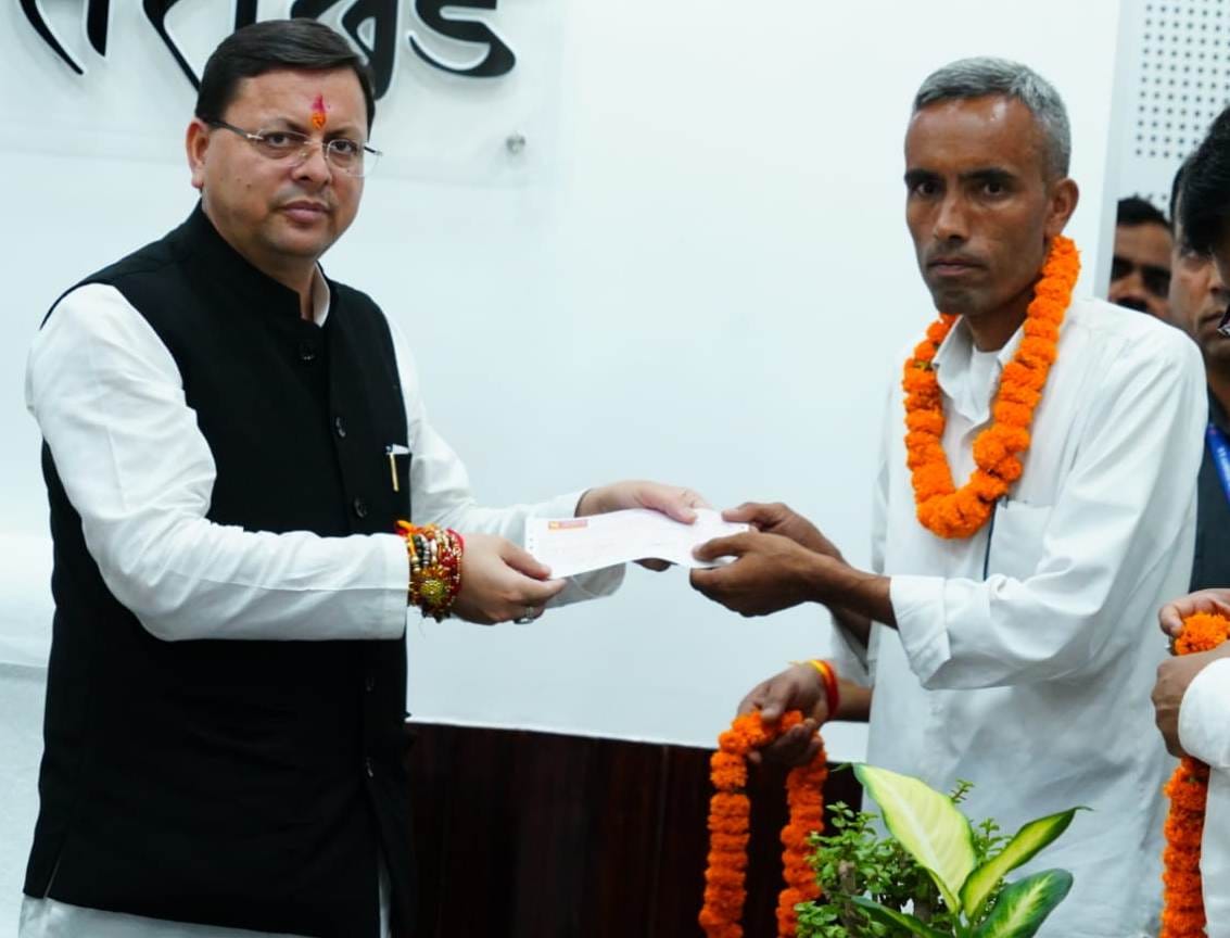 Chief Minister Pushkar Singh Dhami distributed compensation amount to the affected farmers of Vinhar area of Pachwadun, Jakhan during the construction of 220 KV line of Vyasi Hydro Power Project at Chief Minister's Camp Office on Saturday.