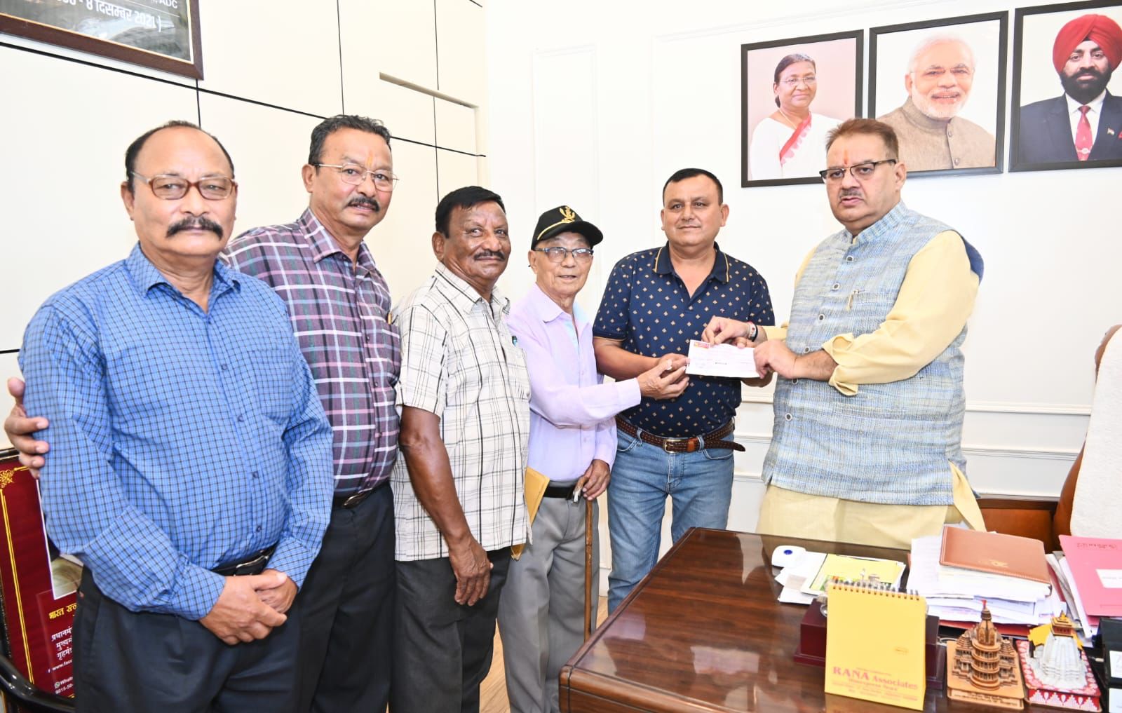 Sainik Welfare Minister Ganesh Joshi presenting a check of assistance amount to All India Gorkha Ex-Servicemen Association.