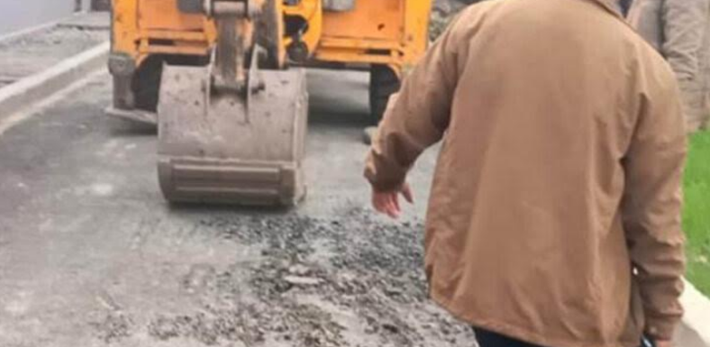 Negligently constructed road broken by JCB